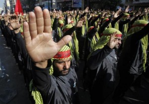Lebanese Hezbollah supporters gesture as they march during a religious procession to mark Ashura in Beirut's suburbs